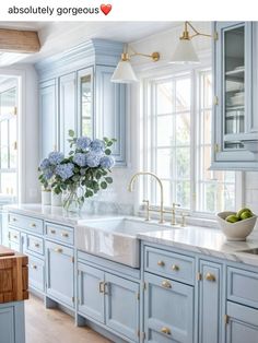 a kitchen with blue cabinets and white marble counter tops is featured in an instagram