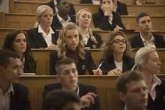 a group of people sitting in rows next to each other