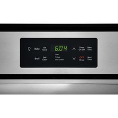 an oven with the time displayed on it's front panel and digital dials