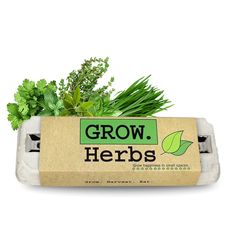 a carton of grow herbs on a white background with green plants growing out of it