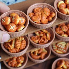 there are many small baskets with food in them on the shelf and someone is holding one