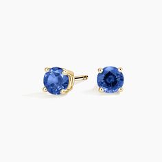 Solitaire Sapphire Stud Ears - 18K Yellow Gold. A beautifully matched pair of brilliant blue sapphires are secured in classic four-prong basket settings with comfortable push back posts for pierced ears. Classic Round Tanzanite Earrings, Classic Yellow Gold Jewelry With Lab-created Sapphire, Classic Yellow Gold Lab-created Sapphire Jewelry, Classic Blue Sapphire Earrings, Classic Blue Lab-created Sapphire Earrings, Classic Sapphire Birthstone Earrings, Classic Blue Brilliant Cut Earrings, Classic Sapphire Earrings In 14k Gold, Classic 14k Gold Sapphire Earrings