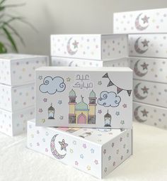 several boxes with designs on them sitting on a table