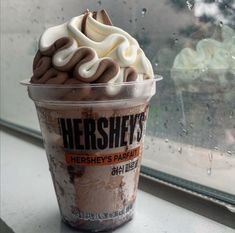 an ice cream sundae sitting on top of a window sill