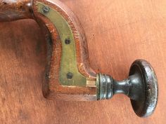 an old wooden door handle with metal knobs