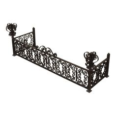 an ornate wrought iron bed frame with decorative designs on the sides and arms, set against a white background