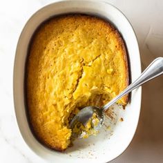 a close up of a cake in a bowl with a spoon