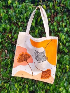 an orange and white bag hanging from a tree