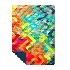 a colorful blanket with an abstract design on the front and back cover, featuring multicolored geometric shapes