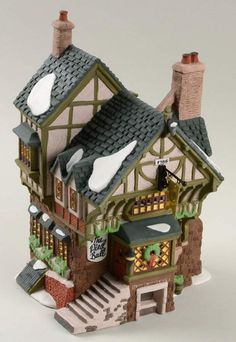 a small toy house is shown on a white surface