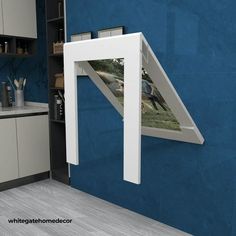 a kitchen with blue walls and white cabinets