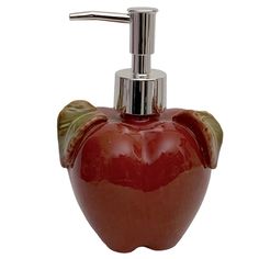 a red apple shaped soap dispenser with a toothbrush holder on it