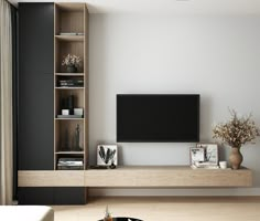 a living room with an entertainment center and bookshelves on the wall in front of a flat screen tv