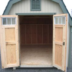 an empty storage shed with the doors open