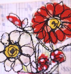 some red and yellow flowers are on a piece of paper that is stitched together