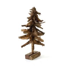 a small wooden christmas tree sitting on top of a piece of wood