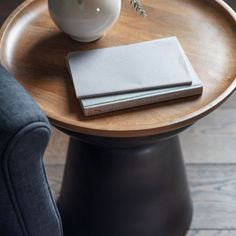 a table with two books and a vase on it