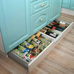 an open drawer in the middle of a kitchen