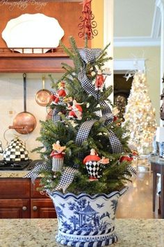 a decorated christmas tree in a blue and white pot