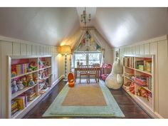 a room with lots of bookshelves and toys on the shelves in front of it