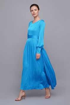 a woman in a blue dress posing for the camera