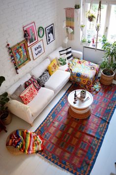 a living room filled with lots of furniture and decor on top of a white floor