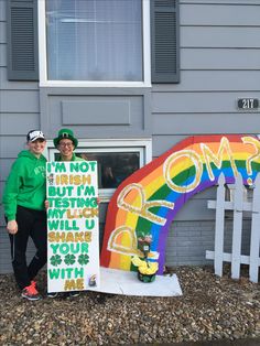 two people standing in front of a building with a sign