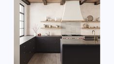 a kitchen with wooden floors and white walls, black cabinets and an island in the middle