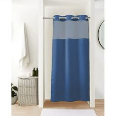 a blue shower curtain in a bathroom