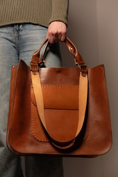 We want to make your life as comfortable as it possible!  That's why we've made a leather designer luxury bag (shopper) by hands with a big love and passion ♥️ ⚒ This handcrafted shopper-bag is made from premium Italian leather in rich brown color. It features a magnet and straps, combining style and practicality.  🙌The bag's voluminous design allows you to fit all your belongings while remaining stylish. ☑️ Each bag is unique, making it a one-of-a-kind accessory. About the Bag: *Size: 36x32x10 Luxury Canvas Bag With Leather Handles For Everyday, Luxury Artisan Shoulder Bag With Leather Backing, Luxury Bags With Grained Texture For Daily Use, Luxury Recycled Leather Bag For Everyday, Luxury Recycled Leather Everyday Bag, Luxury Casual Bag With Leather Trim, Luxury Bags With Leather Lining And Coated Canvas, Luxury Canvas Bags With Leather Backing, Luxury Artisan Bags For Everyday