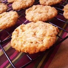 some cookies are cooling on a rack and sitting on a tablecloth covered table cloth