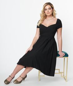 You’re simply marvelous, darling! A fabulous mid-century silhouette in bewitching black, the Midge Dress fro Unique Vintage is a stunning addition to your retro wardrobe. Crafted in a divine stretch blend, the sultry sweetheart neckline tops a darted bodice with an adorable centerpiece of a faux button tab. The wide and pointed waistband slims and elongates your hourglass while the sweet short sleeves are topped by an elastic band for an off the shoulder look. The sweeping swing skirt features p Retro Wardrobe, Sweetheart Neckline Top, Vintage Brand Clothing, Uv Clothing, Dresses 1950s, 1950s Outfits, Guest Attire, Wedding Attire Guest, Womens Vintage Dresses