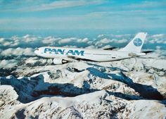 an airplane is flying over the snow covered mountain tops in the sky with mountains below