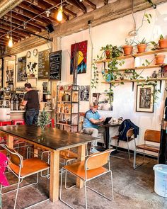 two people sitting at a table in a coffee shop