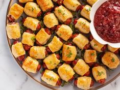 a plate full of croutons with ketchup on the side