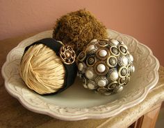 three balls of yarn are sitting on a plate