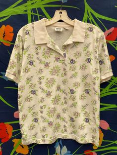 vintage floral button up polo shirt Collared Polo Shirt With Buttons For Summer, Spring Collared Printed T-shirt, Spring Short Sleeve Polo Shirt, Cotton Floral Print Collared Camp Shirt, Collared Cotton Tops With Floral Print, Spring Polo Collar Top With Button Closure, Spring Tops With Johnny Collar, Collared Cotton Shirt With Floral Print, Spring Cotton Camp Shirt With Floral Print