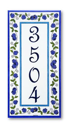 a blue and white house number sign with flowers on the border, in front of a white background