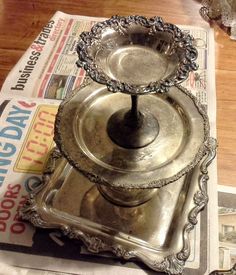 two silver dishes sitting on top of each other