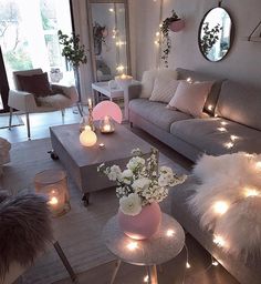 a living room filled with lots of furniture and candles on top of it's tables