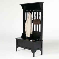 a black bench with a coat rack and purses