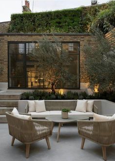 an outdoor living area with wicker furniture