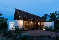 a white house with a wooden roof at night