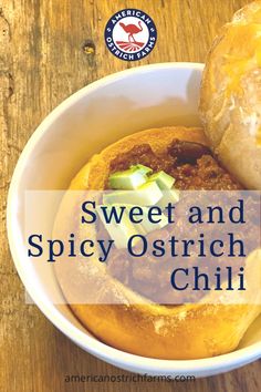 sweet and spicy ostrich chili in a white bowl on a wooden table with text overlay