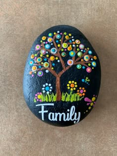 a painted rock with a family tree on it