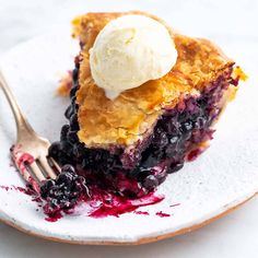 a slice of blueberry pie with ice cream on top