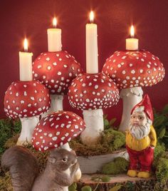 a group of mushrooms sitting next to each other on top of a table with candles