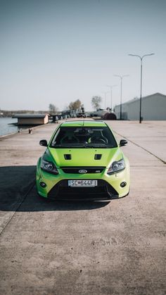 a bright green car parked in a parking lot