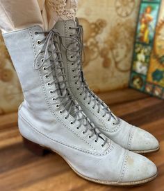 "One of many Edwardian mens/women's boots that we have for sale in our Etsy TeaTime shop. A fabulous pair of Antique womens Edwardian \"granny\" boots. An off white color, with just a hint of gray. Unique wingtip style design to the uppers (refer to Photos) made in smooth leather, with naturally distressed details and a lower block heel. 18 grommet hole granny boot. Brown Leather sole.*Refer to last photo and condition comments below for details. Size: REFER TO SIZE CHART INCLUDED no size indica Vintage Fitted Lace-up Boots With Snip Toe, Victorian Boots With Leather Sole, Victorian Style Fitted Leather Boots, Fitted Victorian Leather Boots, Vintage Fitted Cap Toe Boots, Fitted Vintage Cap Toe Boots, Fitted Cap Toe Vintage Boots, Victorian Almond Toe Fitted Boots, Silent Sky