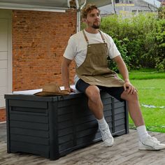 a man sitting on top of a wooden bench